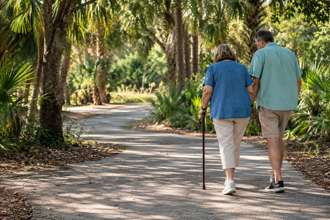Illustrative adults walking with support in a Florida park